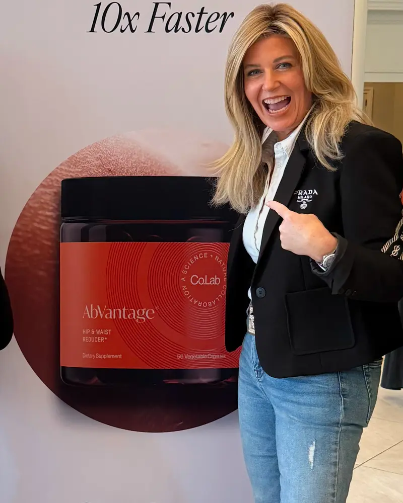 Dr. Kristal smiling and pointing to a Co.Lab AbVantage display